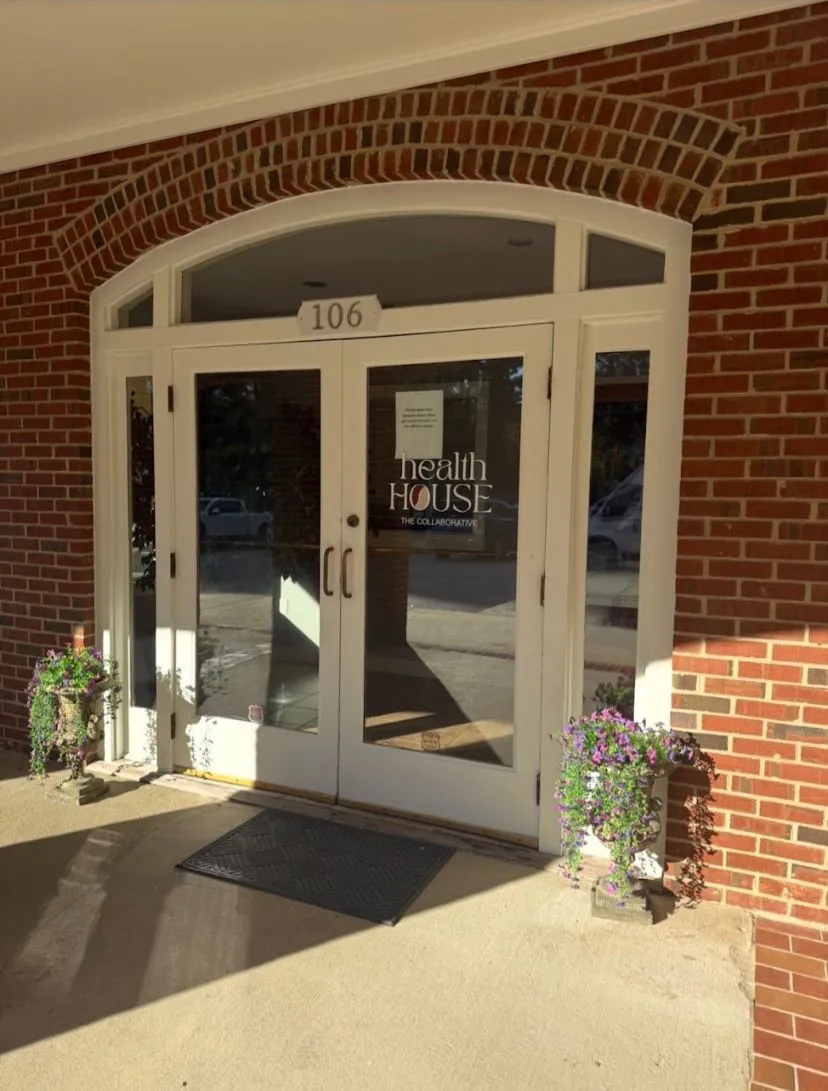 Brick-front entrance marked 106 for Health House Collaborative in Raleigh.